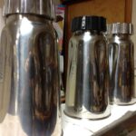 row of three stainless steel milkshake cups