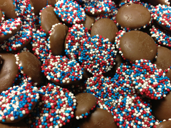 milk chocolate drops with one side coated in red, white and blue sprinkles